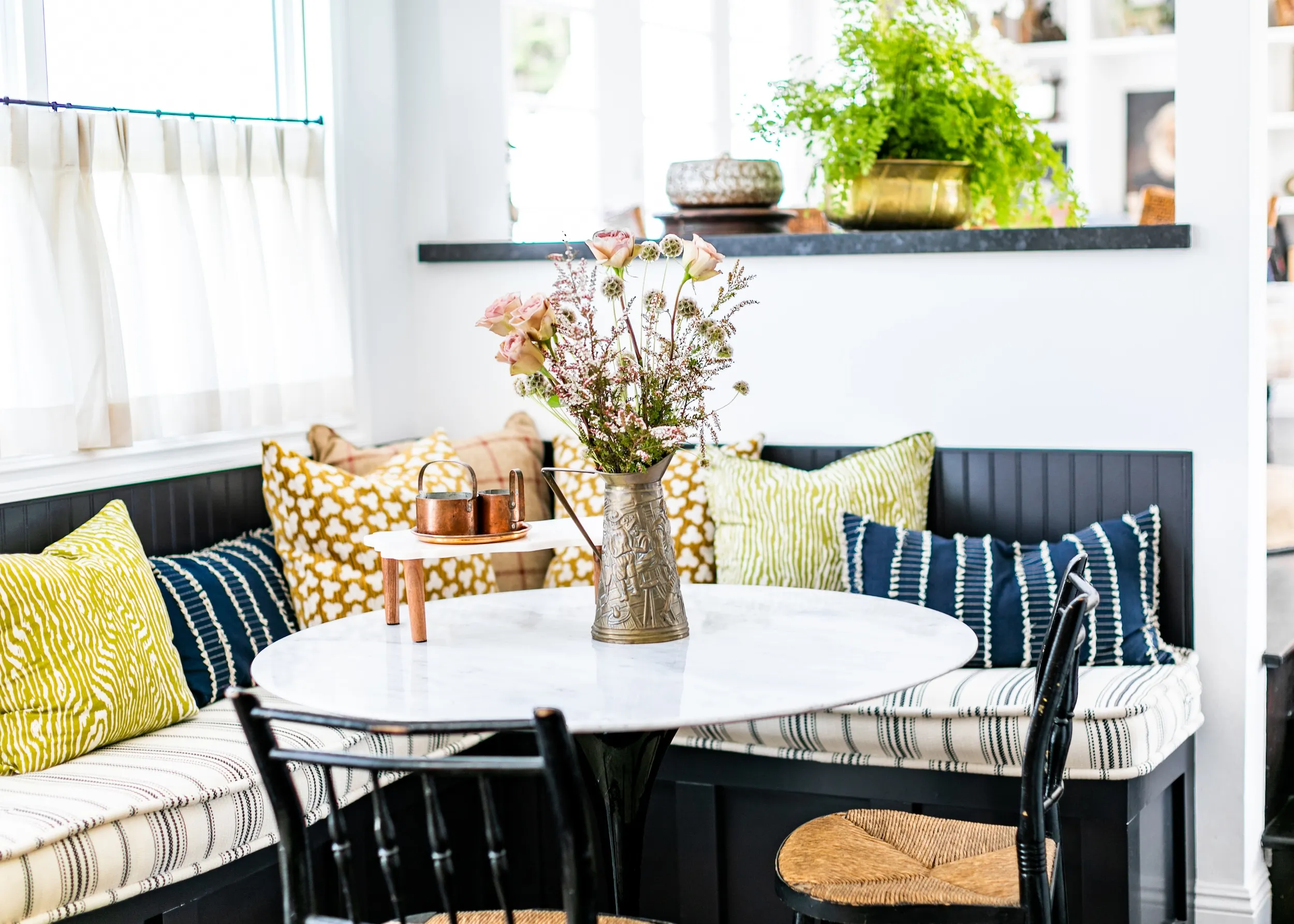 Dining room bench and table with flowers